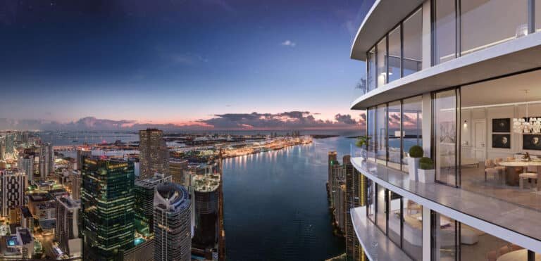 Luxury balcony view from Baccarat Residences Brickell overlooking Biscayne Bay and downtown Miami skyline at twilight.