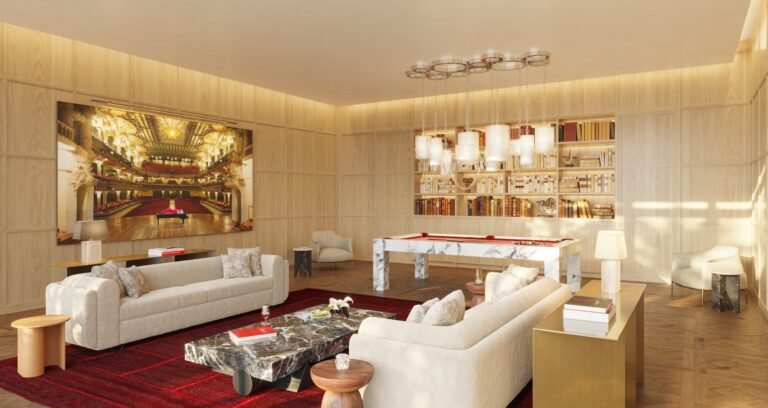 Billiards lounge at Baccarat Residences Brickell with marble pool table, bookshelves, sofas, and dramatic art wall.