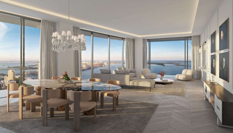 Living and dining area at Baccarat Residences Brickell with floor-to-ceiling windows and wide Biscayne Bay views.