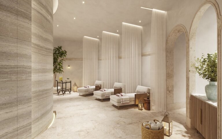 Tranquil spa lounge at Baccarat Residences Brickell with stone walls, sheer curtains, lounge chairs, and soft ambient lighting.