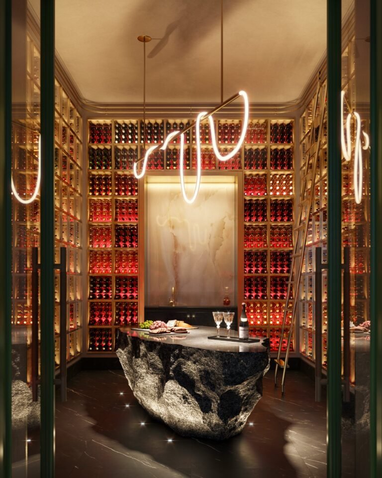 Luxury wine cellar at Baccarat Residences Miami featuring illuminated racks, stone island, and modern lighting