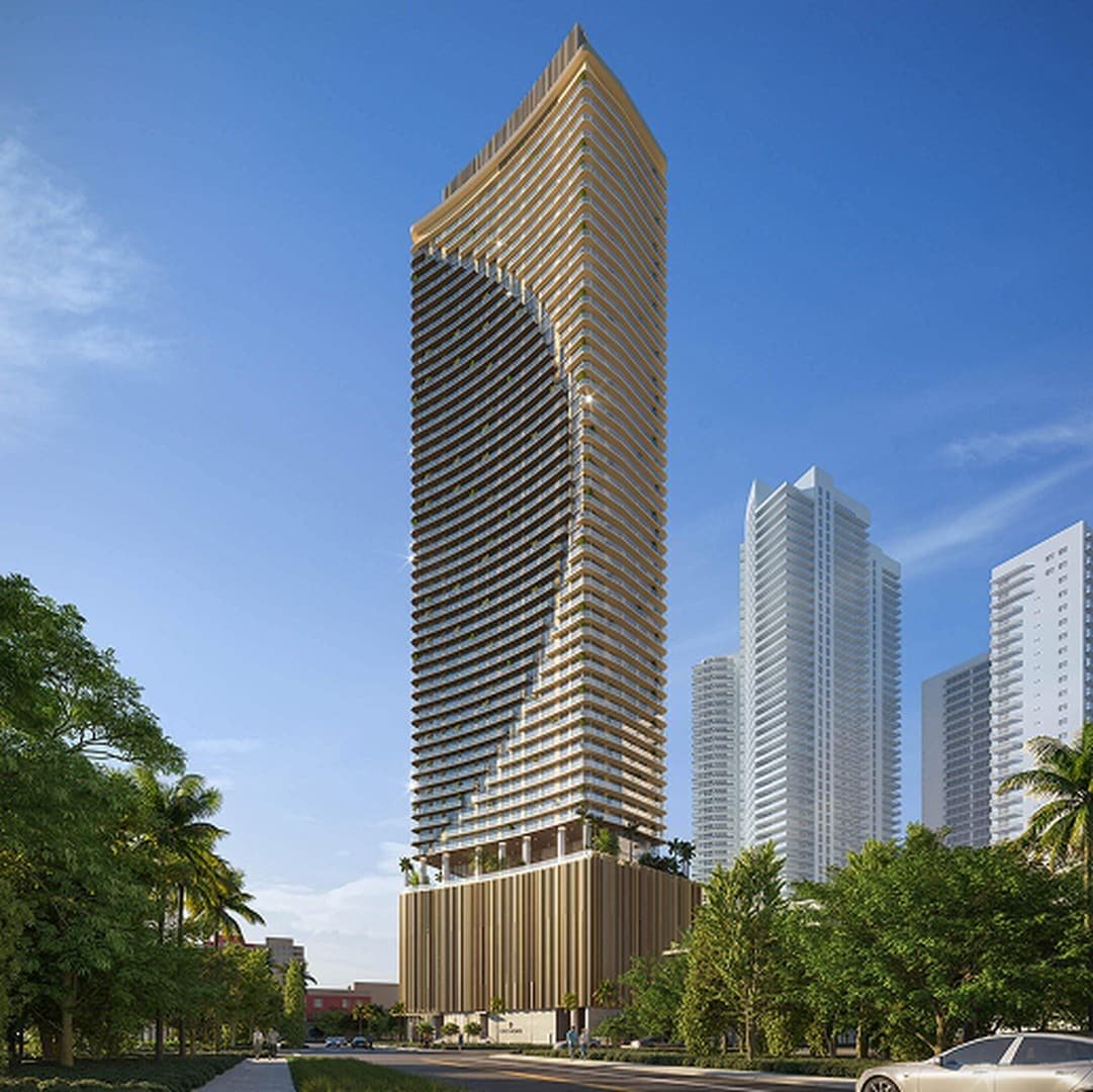 Tall modern skyscraper with a curved, gold-tinted facade against a clear blue sky. Surrounded by greenery and palm trees, flanked by other skyscrapers.