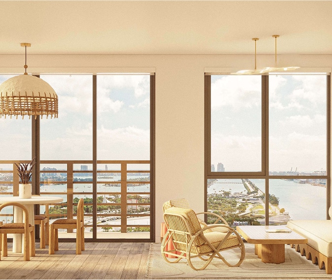 Bright and airy living room with large windows, offering a scenic view of a river and cityscape. Features cozy rattan furniture and a pendant lamp, creating a serene ambiance.