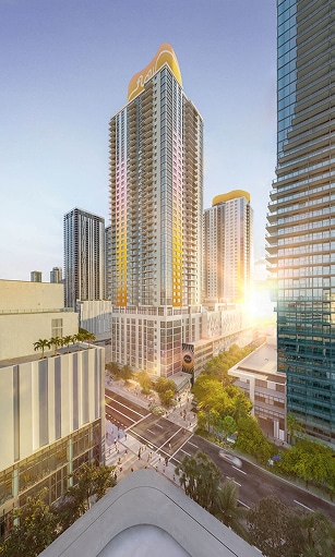 Aerial view of a bustling city intersection with high-rise buildings. The sunset casts a golden glow, illuminating the skyline and creating a vibrant, warm atmosphere.