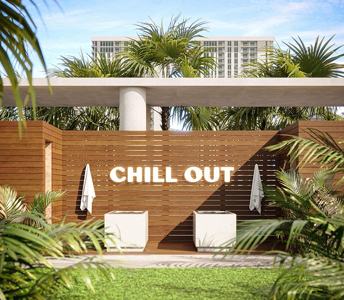 A wooden poolside wall with "CHILL OUT" in bright letters. Flanked by tropical plants and light towels, conveying a relaxing, serene vibe.