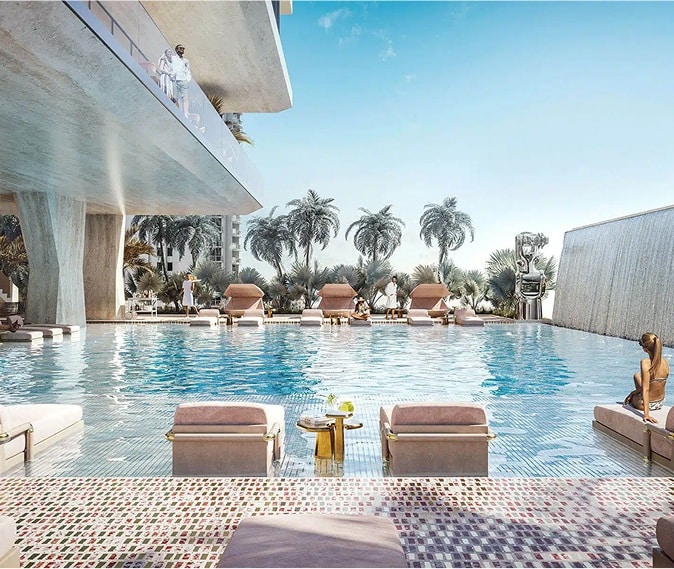 Luxury pool deck with lounge chairs and waterfall feature at Dolce & Gabbana Residences Miami.