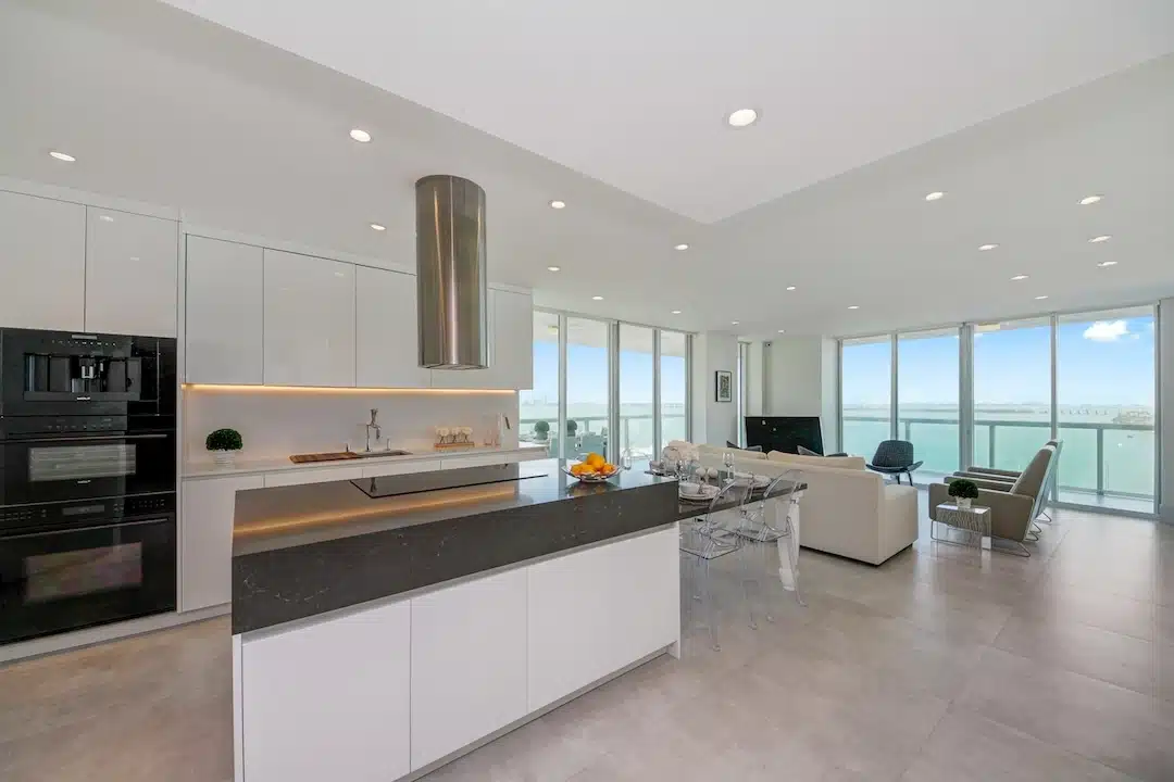 Modern waterfront condominium interior on Belle Isle, Miami Beach with open kitchen and bay views.