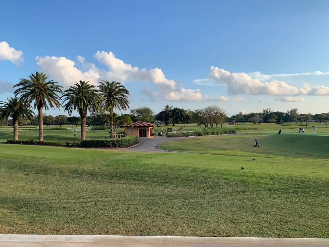 Biltmore Golf Course in Coral Gables featuring manicured fairways, palm trees, and golfers enjoying a classic South Florida course.