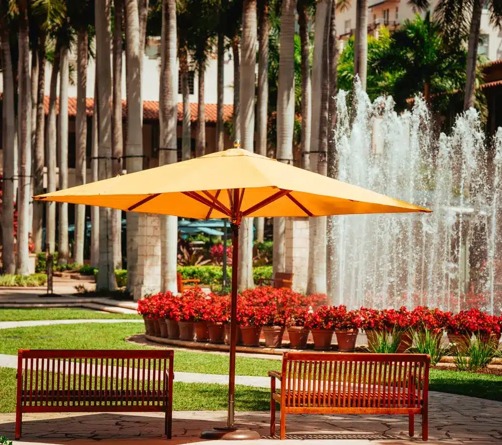 Mediterranean-style plaza in Coral Gables with palm trees, fountains, shaded seating, and landscaped gardens reflecting the city’s character.