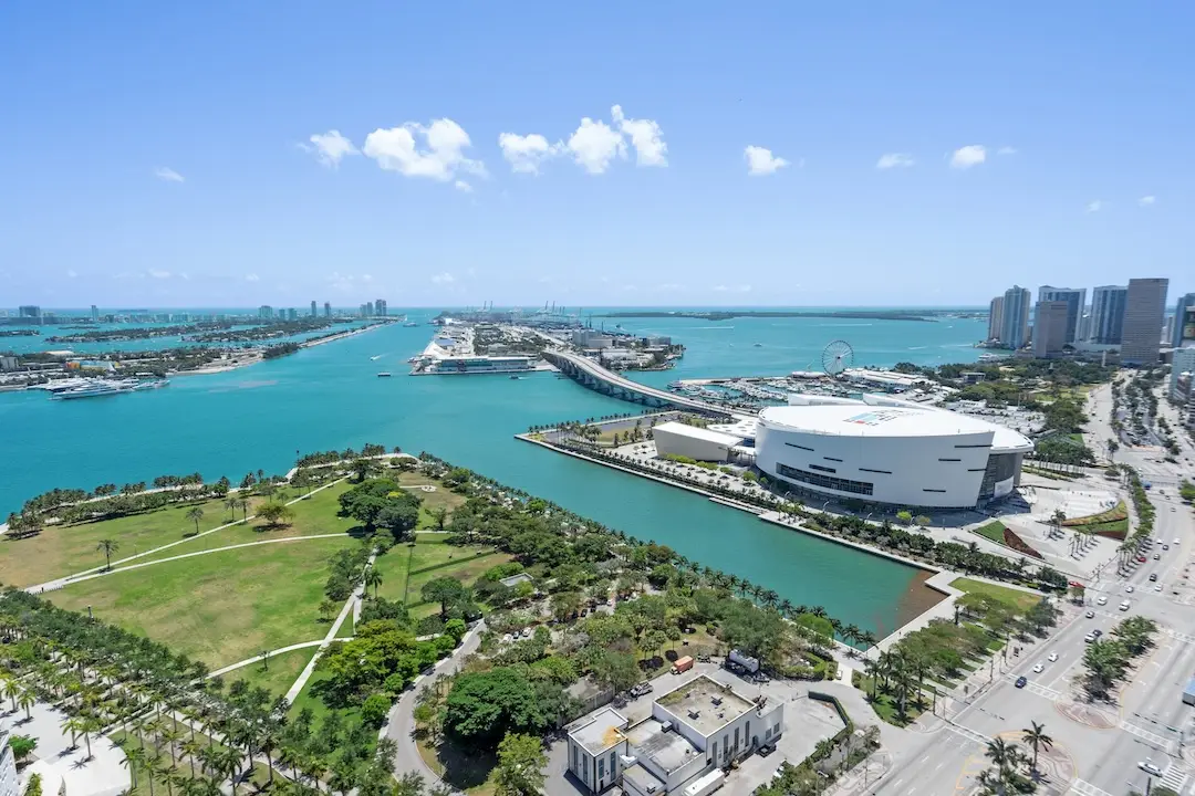 Aerial view of Downtown Miami showcasing Biscayne Bay, Museum Park, the Kaseya Center area, and Miami’s skyline along the waterfront.
