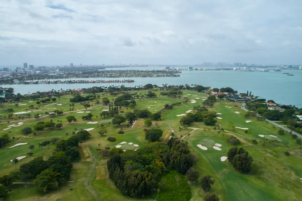 Aerial view of the golf course on Indian Creek Island with Biscayne Bay in the background
