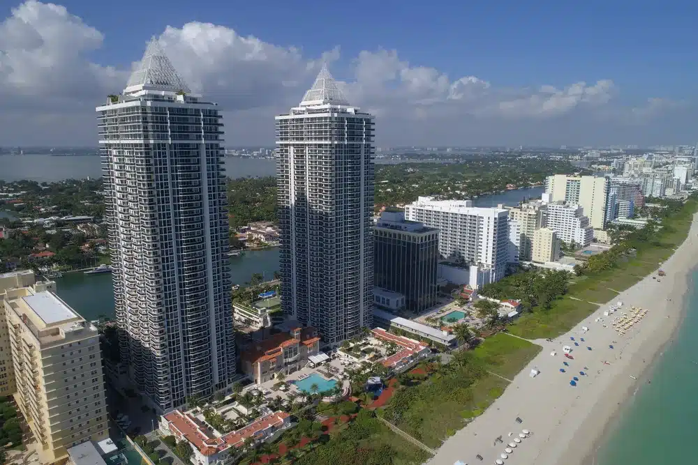 Aerial view of oceanfront condominium towers along Mid Beach in Miami Beach