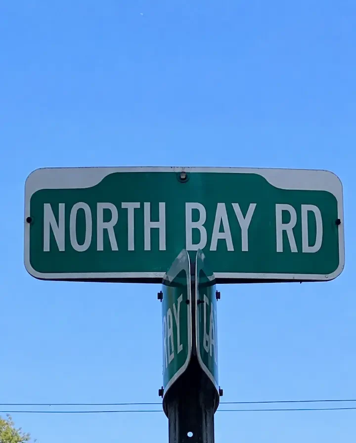 North Bay Road street sign against blue sky in Miami Beach.