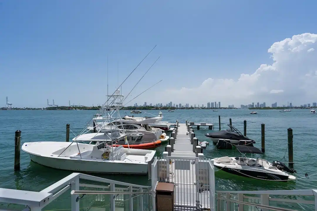Private marina dock with boats and Miami skyline views across Biscayne Bay in South Beach.