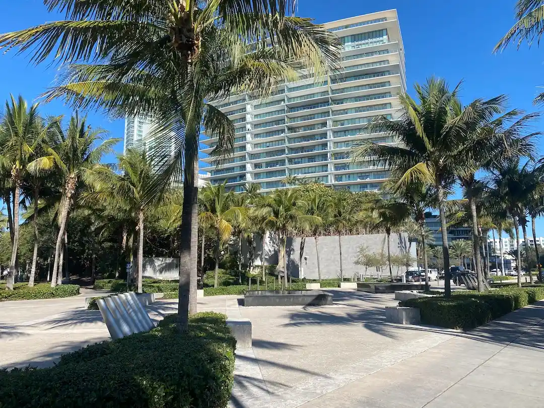 Palm-lined pedestrian plaza with modern condo buildings near South Pointe Park in the South of Fifth neighborhood of Miami Beach.