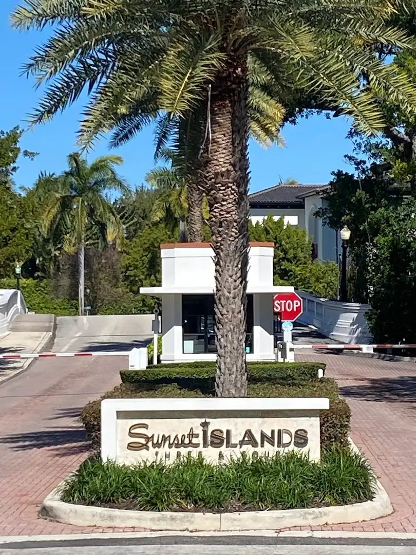 Entrance sign and guard gate at Sunset Islands, a gated waterfront neighborhood in Miami Beach.