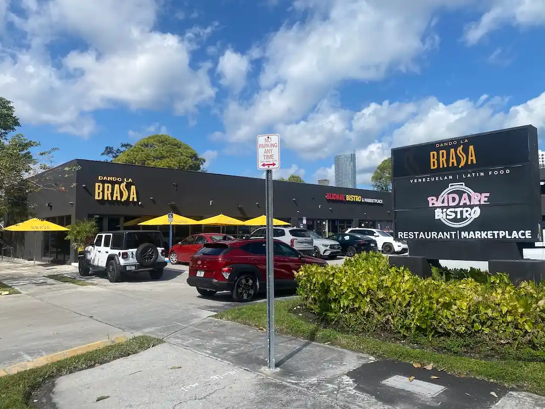 Dando La Brasa and Budare Bistro restaurants in The Roads Miami with outdoor seating and neighborhood parking.