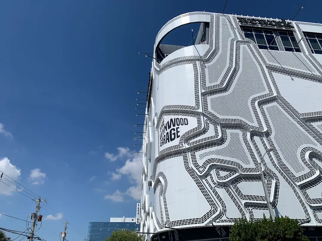 Wynwood Garage in Miami featuring a modern white architectural facade with geometric patterns against a blue sky.